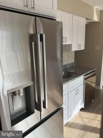 a stove top oven sitting inside of a kitchen