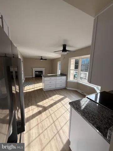 a kitchen with granite countertop a stove and a refrigerator