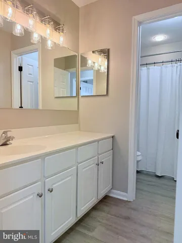 a bathroom with a double vanity sink and mirror