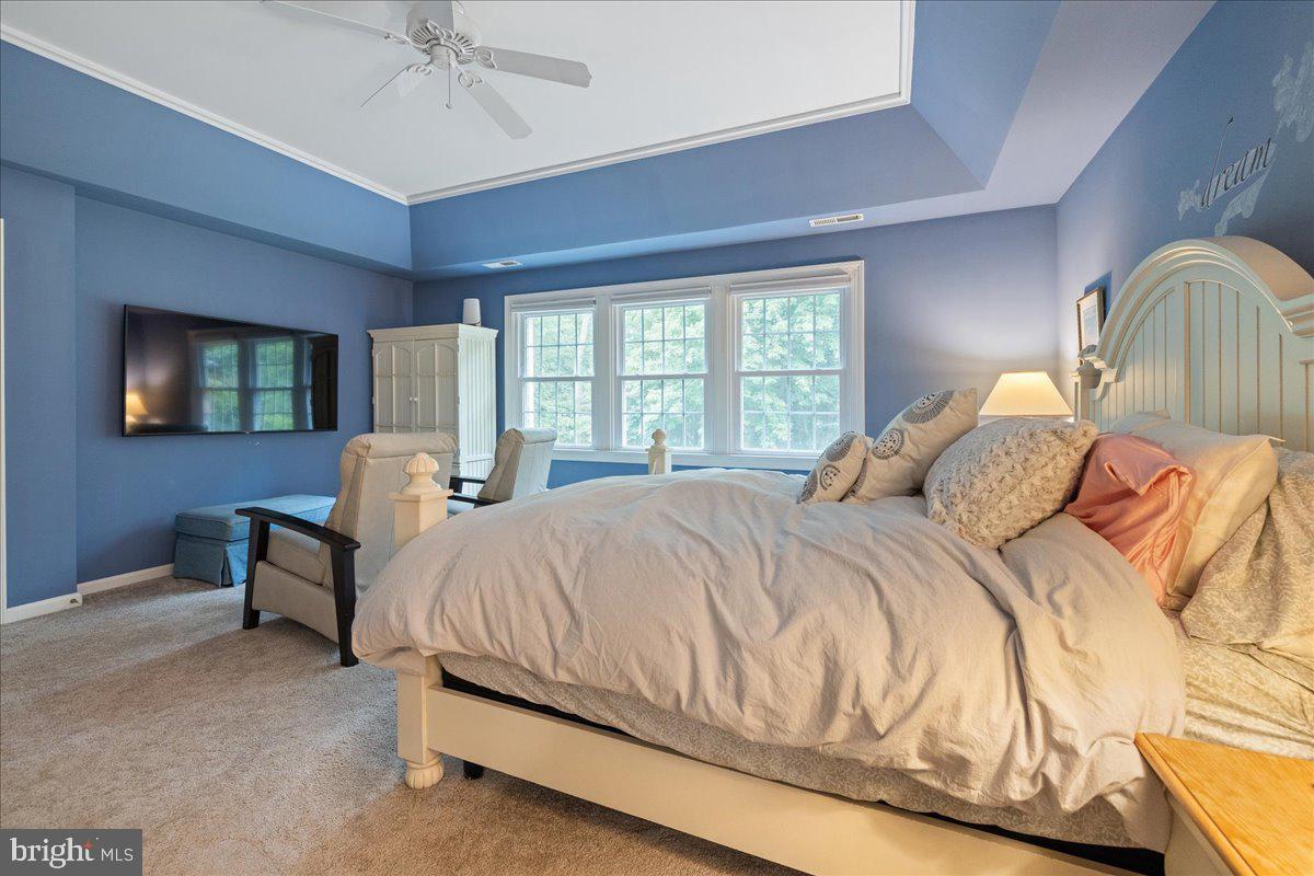 10 Eagleton Farm Road Newtown, PA 18940 - Photo 20 of 39 a bed sitting in a bedroom next to a window with a chandelier