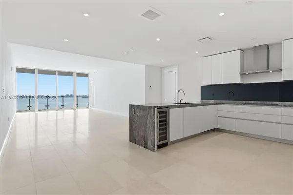 a view of kitchen with stainless steel appliances a sink and cabinets