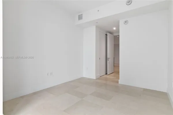 a bedroom with a bed and wall painting