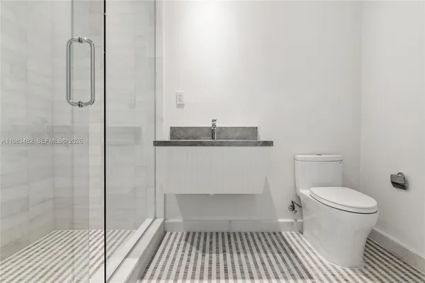 a view of a walk in closet and a tub