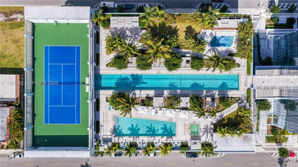 a view of a backyard with table and chairs with wooden fence