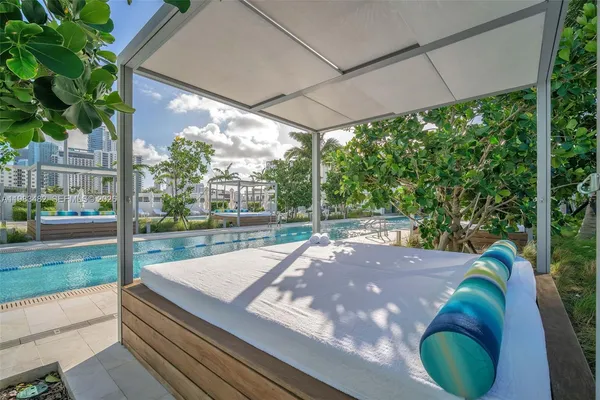 a view of swimming pool with outdoor seating