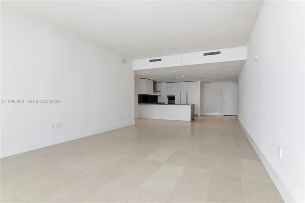 a view of a big room with closet and windows