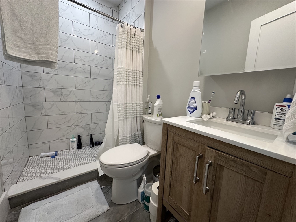 68 L Street, Unit 1 Boston, MA 02127 - Photo 8 of 12 a bathroom with a sink toilet and shower