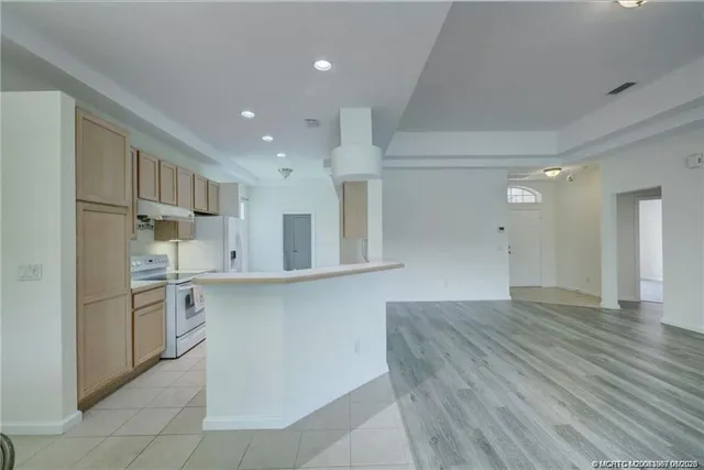 a kitchen with a stove a refrigerator and a sink