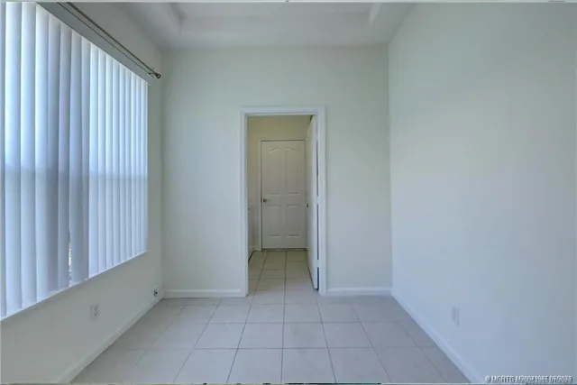 a view of a kitchen with a sink and dishwasher a refrigerator with white cabinets