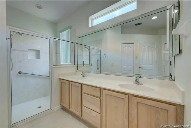 a bathroom with a granite countertop toilet a sink and a mirror