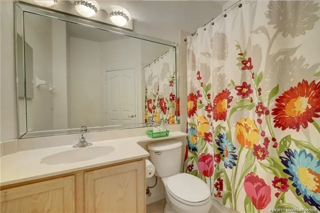 an empty room with a ceiling fan and carpet