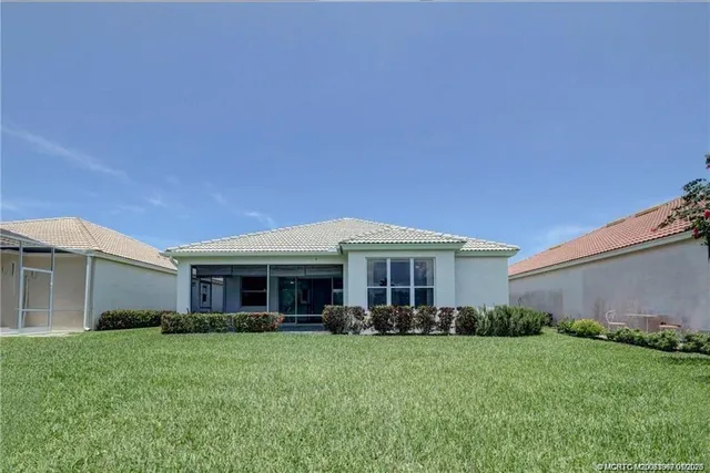 an aerial view of a house with a swimming pool and outdoor space