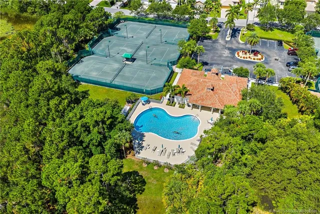 a view of yard with swimming pool and green space