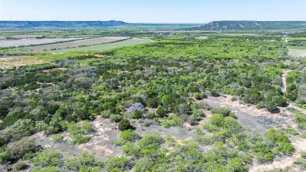 a view of a green field with an ocean view