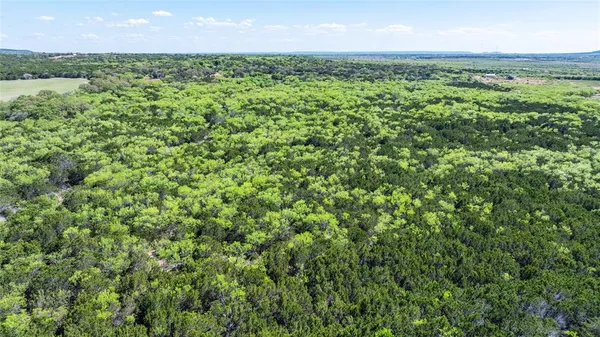 an aerial view of a houses with a yard