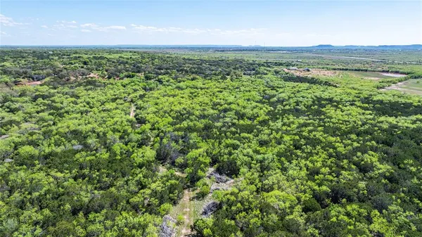 an aerial view of a houses with a yard