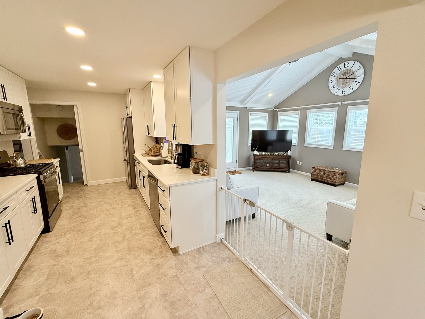 515 Roberts Lane Batavia, IL 60510 - Photo 8 of 42 a kitchen with a sink a counter top space stainless steel appliances a flat screen tv and a window