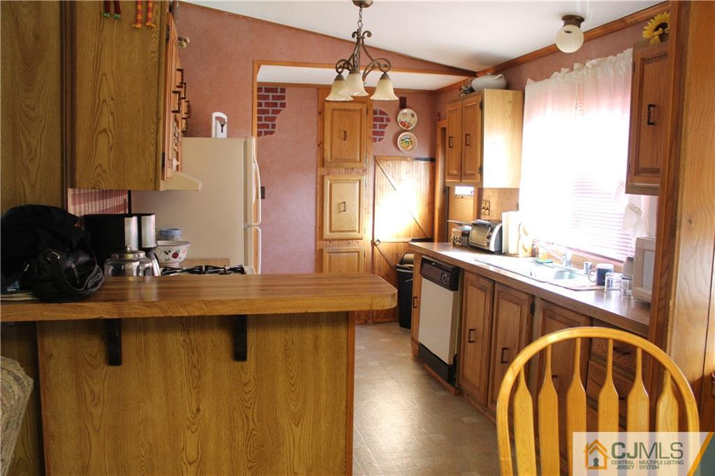 5 Poe Road North Brunswick, NJ 08902 - Photo 10 of 10 a view of a kitchen with kitchen island granite countertop a sink and a refrigerator