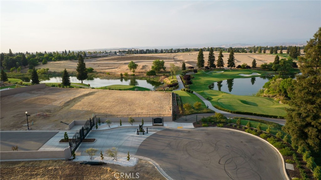 2490 East Copper Ridge Drive Fresno, CA 93730 - Photo 20 of 20 a play ground with the view of lake and houses in the back