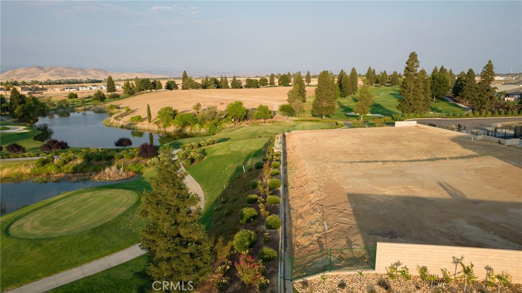 2490 East Copper Ridge Drive Fresno, CA 93730 - Photo 5 of 20 a view of a swimming pool with a yard