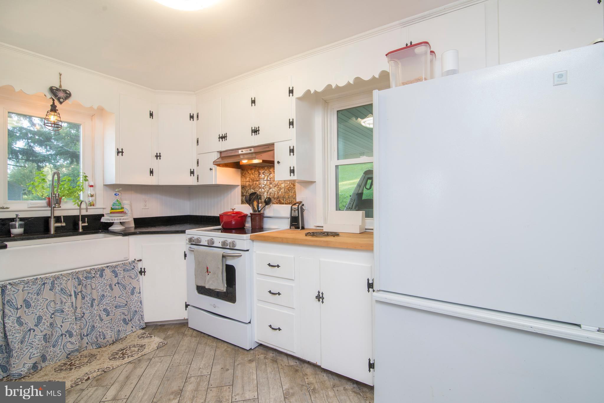 6227 Clevelandtown Road Boonsboro, MD 21713 - Photo 13 of 30 a kitchen with white cabinets and white appliances