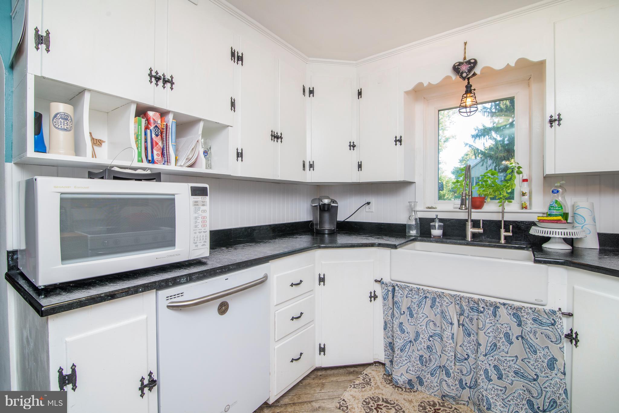 6227 Clevelandtown Road Boonsboro, MD 21713 - Photo 14 of 30 a kitchen with stainless steel appliances white cabinets and a stove top oven