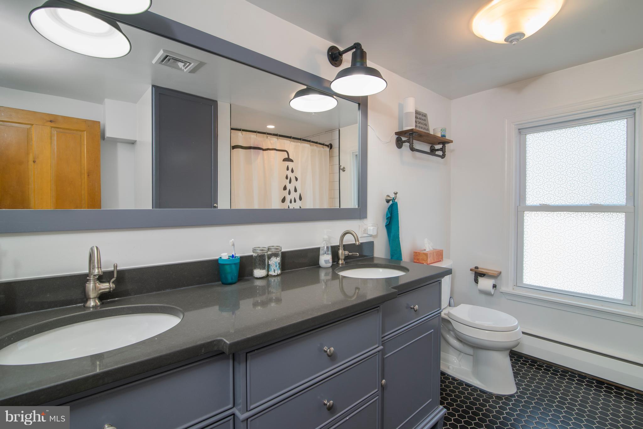 6227 Clevelandtown Road Boonsboro, MD 21713 - Photo 22 of 30 a bathroom with a granite countertop sink a toilet and a mirror
