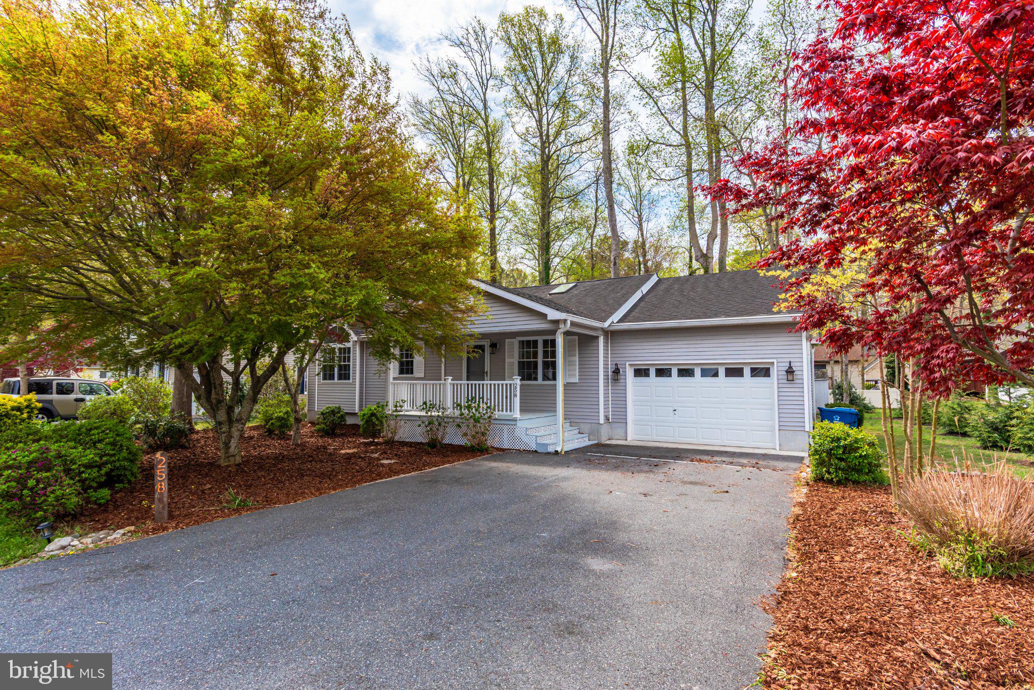Charming home with vibrant landscaping.