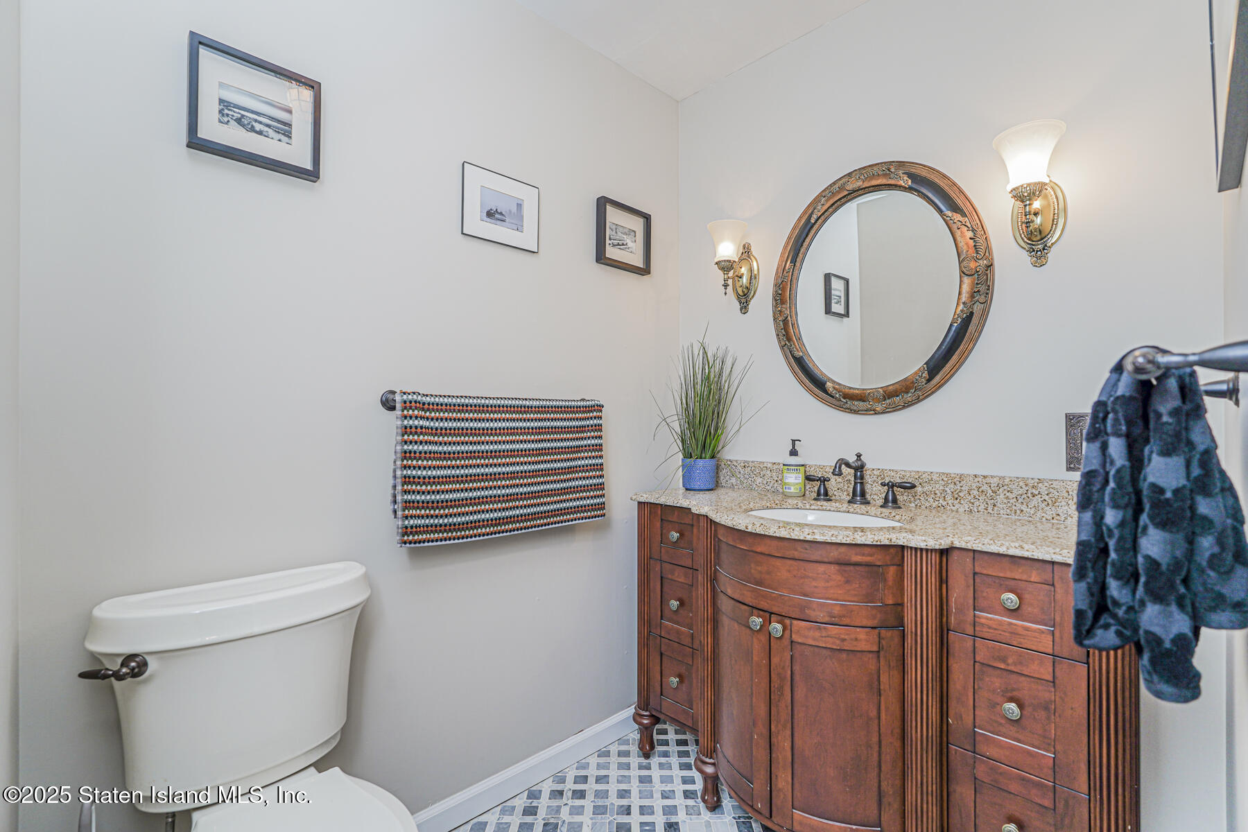 20 Signal Hill Road Staten Island, NY 10301 - Photo 16 of 42 a bathroom with a toilet a sink and a mirror