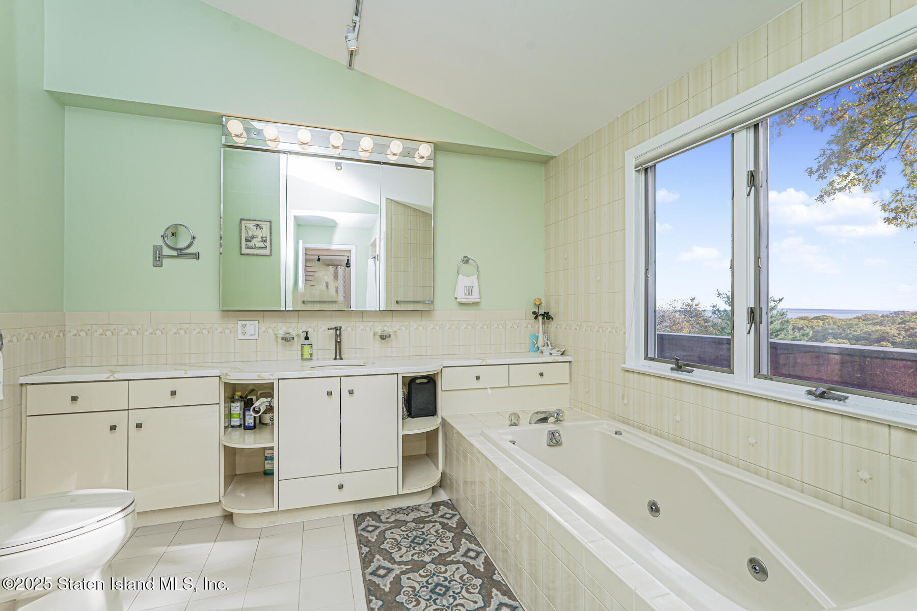 20 Signal Hill Road Staten Island, NY 10301 - Photo 26 of 42 a bathroom with a bathtub sink mirror vanity and toilet
