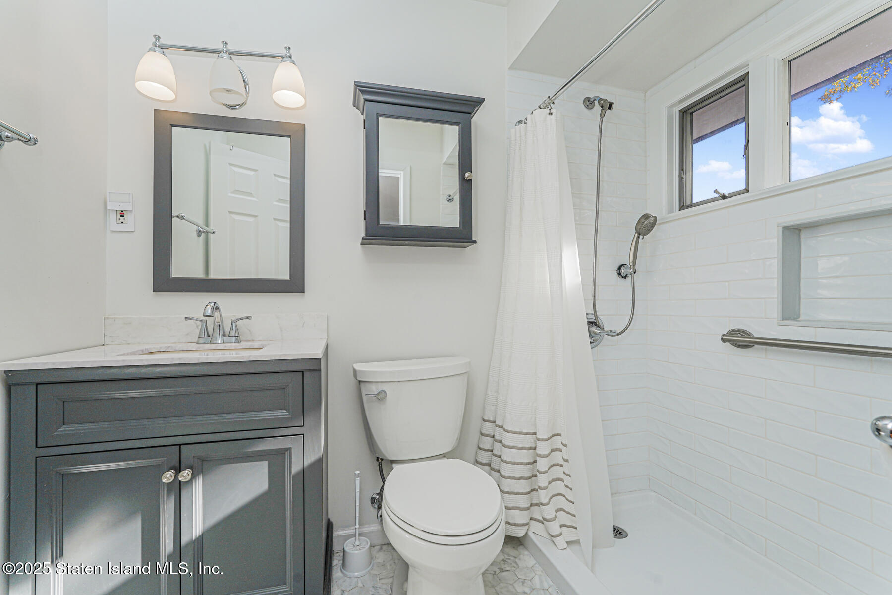 20 Signal Hill Road Staten Island, NY 10301 - Photo 31 of 42 a bathroom with a toilet a sink a mirror and a shower