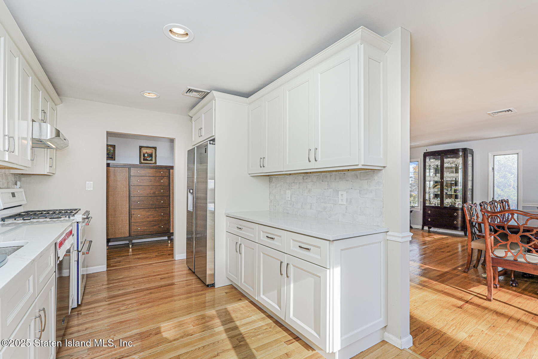 20 Signal Hill Road Staten Island, NY 10301 - Photo 10 of 42 a kitchen with stainless steel appliances granite countertop a refrigerator and a stove top oven