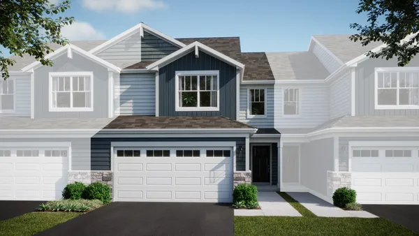 a front view of a house with a yard and potted plants