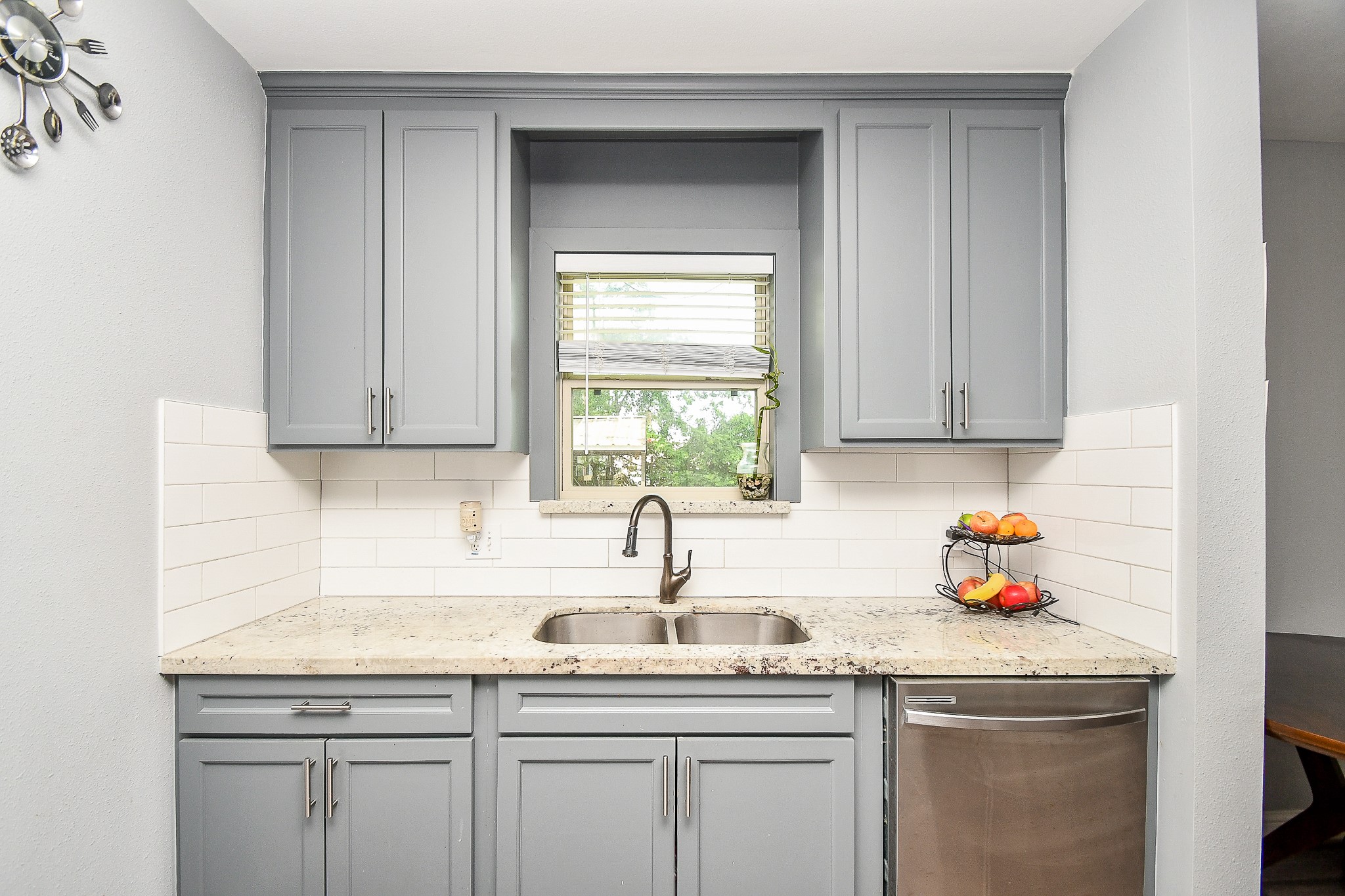 1607 Sylvester Road Houston, TX 77009 - Photo 16 of 32 a kitchen with granite countertop white cabinets and sink