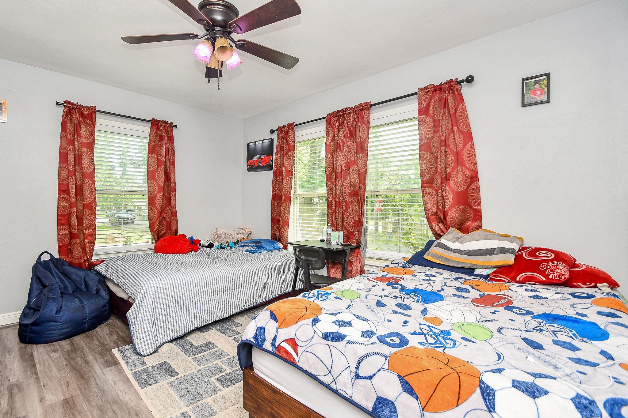 1607 Sylvester Road Houston, TX 77009 - Photo 23 of 32 a bedroom with two beds and a chandelier