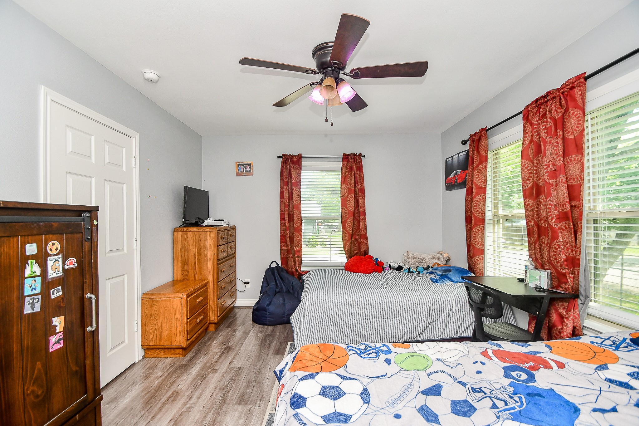1607 Sylvester Road Houston, TX 77009 - Photo 25 of 32 a bedroom with a bed and wooden floor