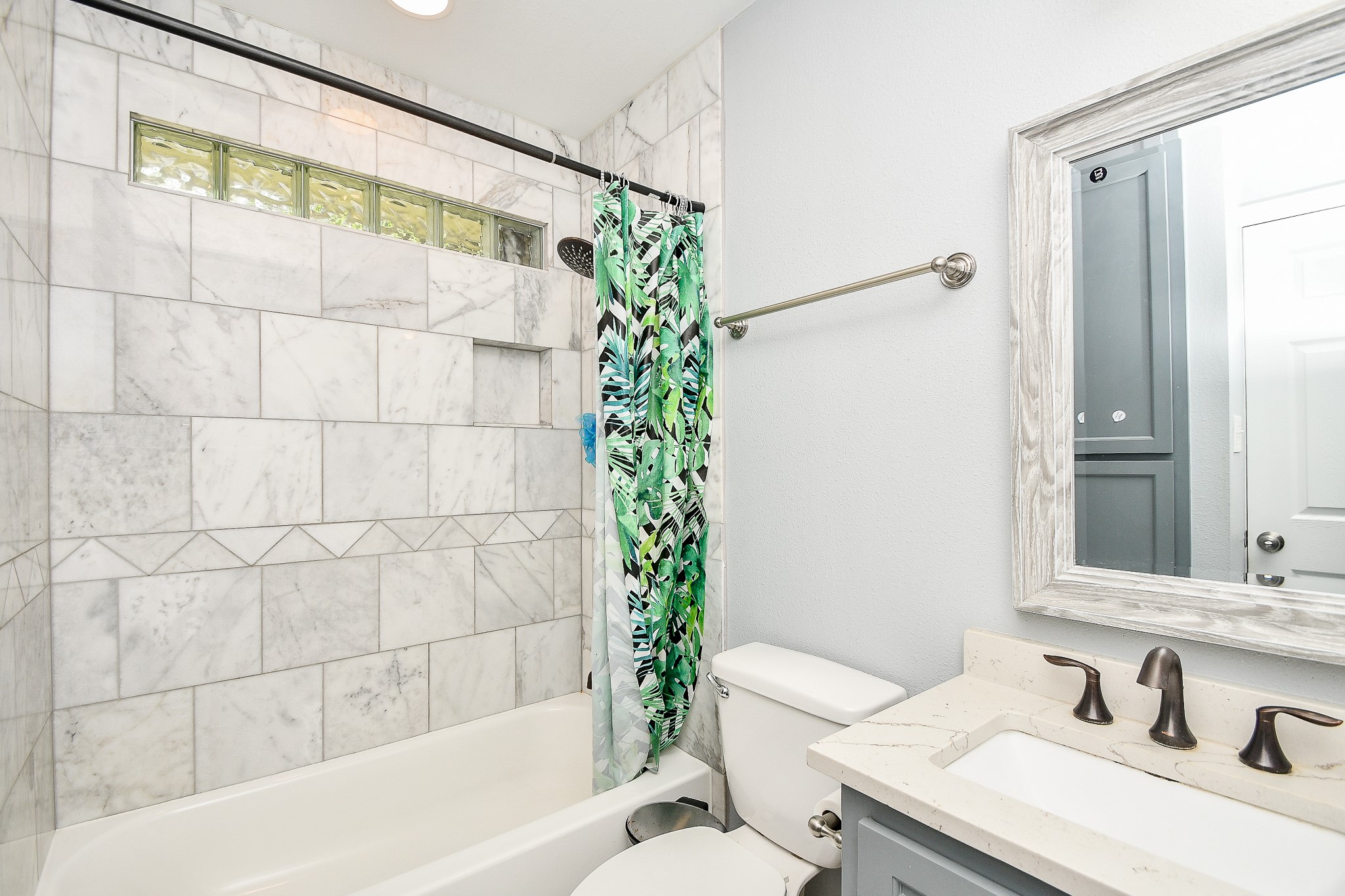 1607 Sylvester Road Houston, TX 77009 - Photo 26 of 32 a bathroom with a sink and a mirror