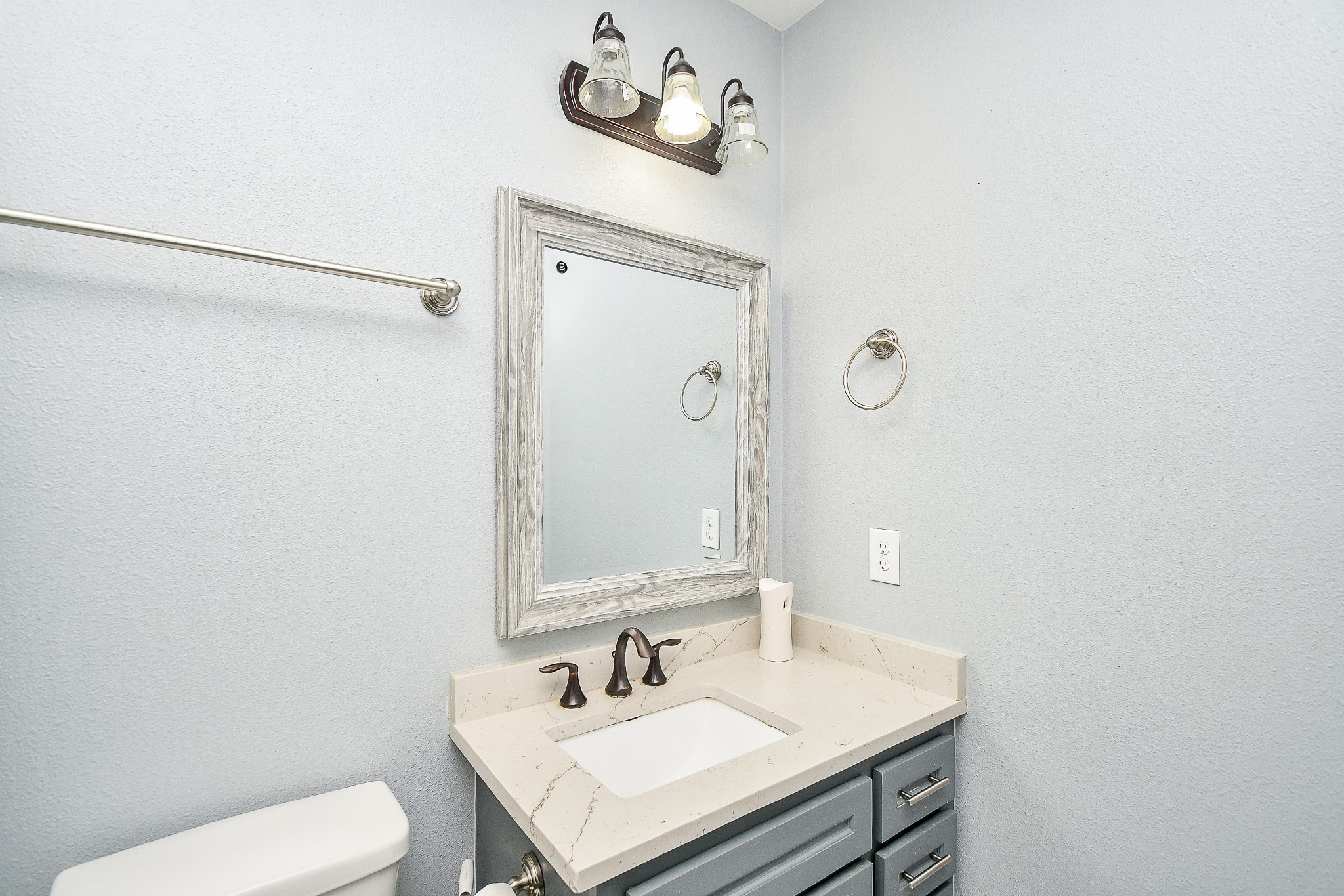 1607 Sylvester Road Houston, TX 77009 - Photo 27 of 32 a bathroom with a sink vanity mirror and toilet