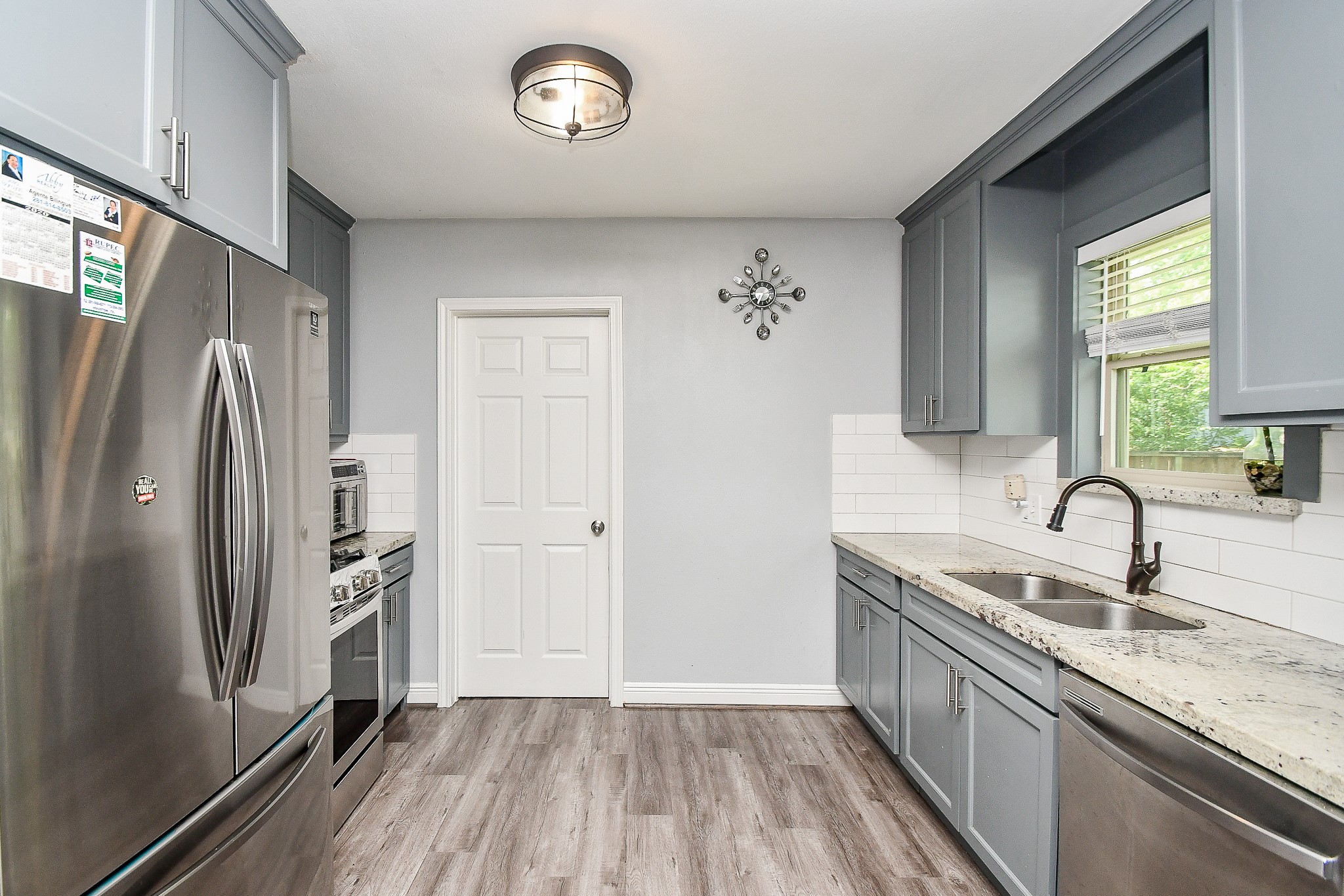 1607 Sylvester Road Houston, TX 77009 - Photo 9 of 32 a kitchen with stainless steel appliances granite countertop a refrigerator and a sink