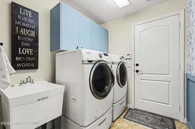 a utility room with dryer and washer