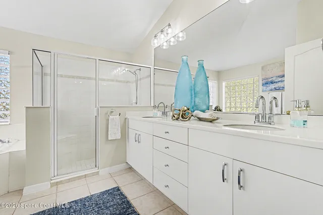 a bathroom with a double vanity sink and a mirror