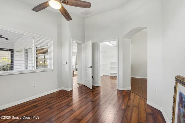 a view of empty room with wooden floor