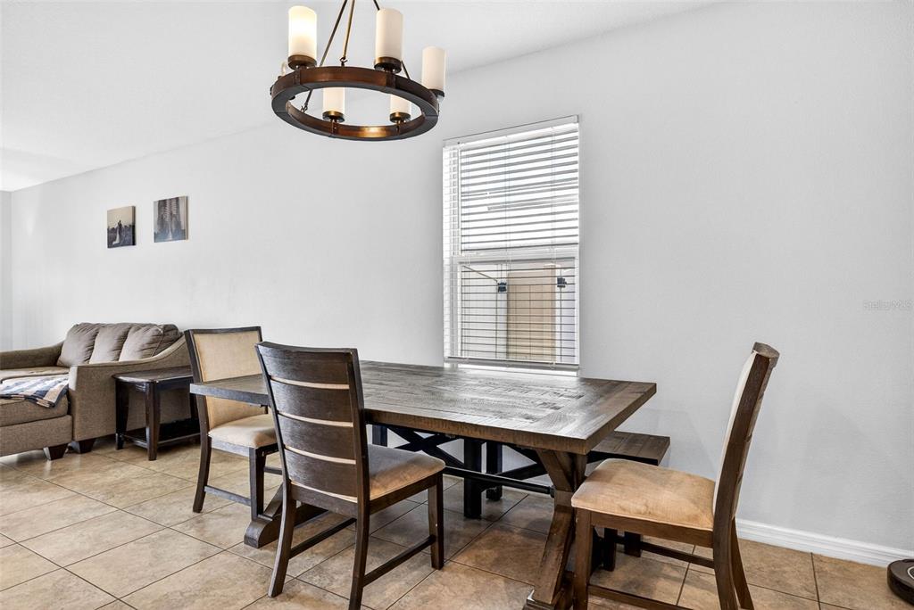 9616 Lemon Drop Loop Sun City Center, FL 33573 - Photo 16 of 53 a view of a dining room with furniture and window