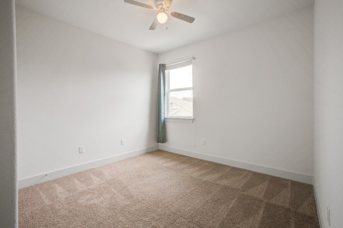 5910 Rubicon Run Austin, TX 78745 - Photo 12 of 18 Unfurnished room with light carpet and a ceiling fan