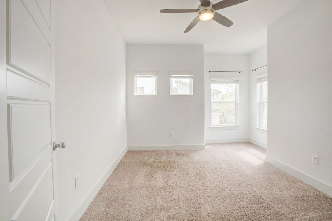 5910 Rubicon Run Austin, TX 78745 - Photo 13 of 18 Spare room featuring a ceiling fan and light colored carpet