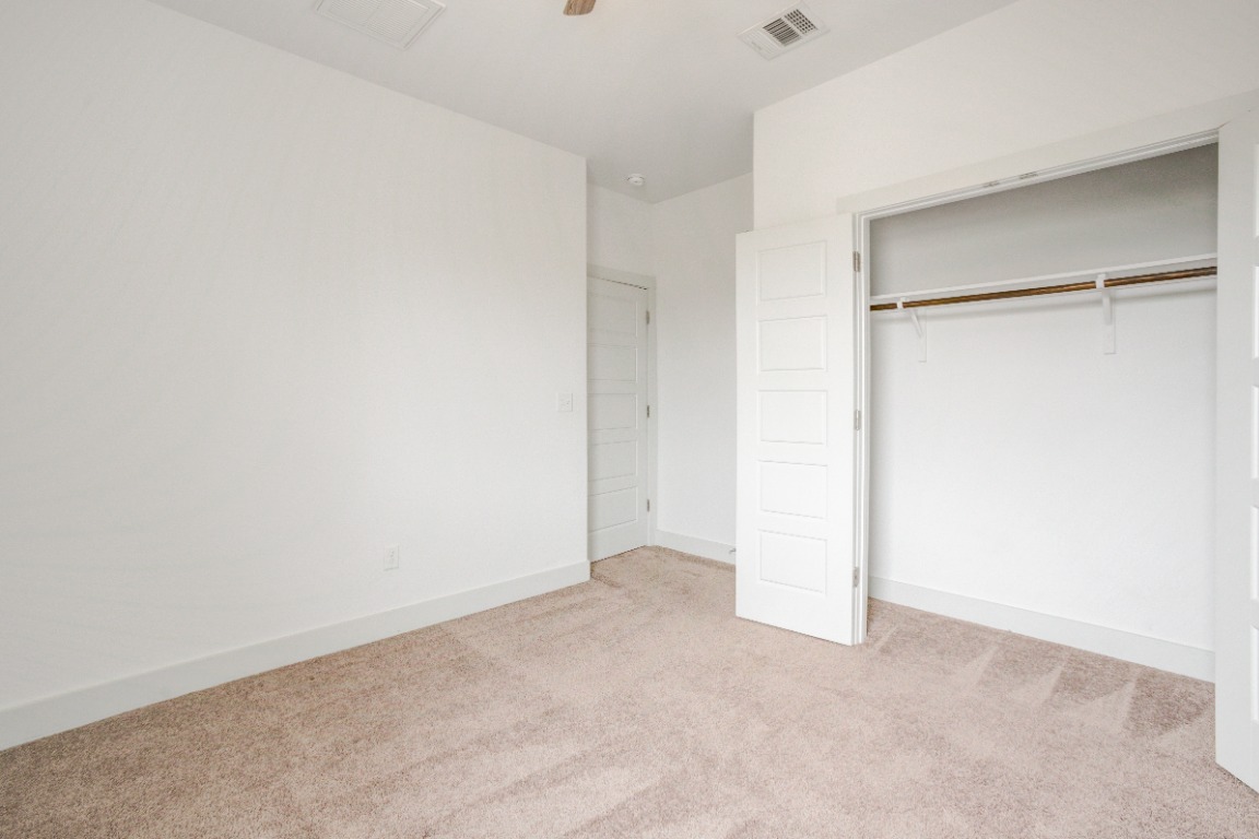 5910 Rubicon Run Austin, TX 78745 - Photo 9 of 18 Unfurnished bedroom featuring light colored carpet, a closet, and ceiling fan