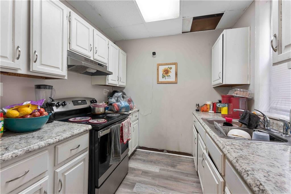 254-256 Pennsylvania Avenue Rochester, PA 15074 - Photo 11 of 32 a kitchen with stainless steel appliances granite countertop a sink stove and cabinets
