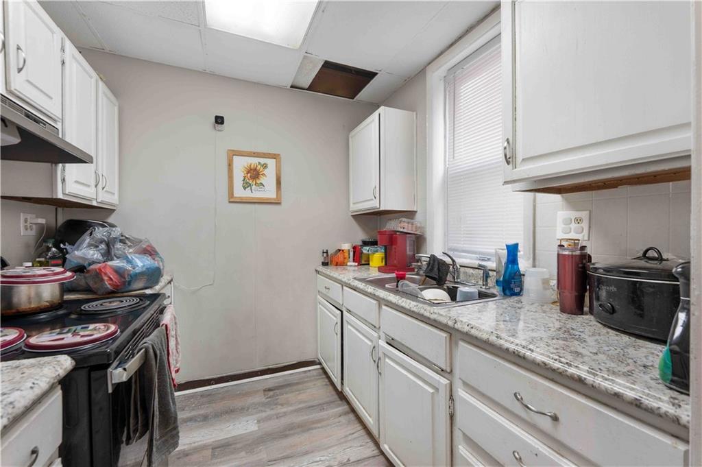 254-256 Pennsylvania Avenue Rochester, PA 15074 - Photo 12 of 32 a kitchen with sink cabinets and stainless steel appliances