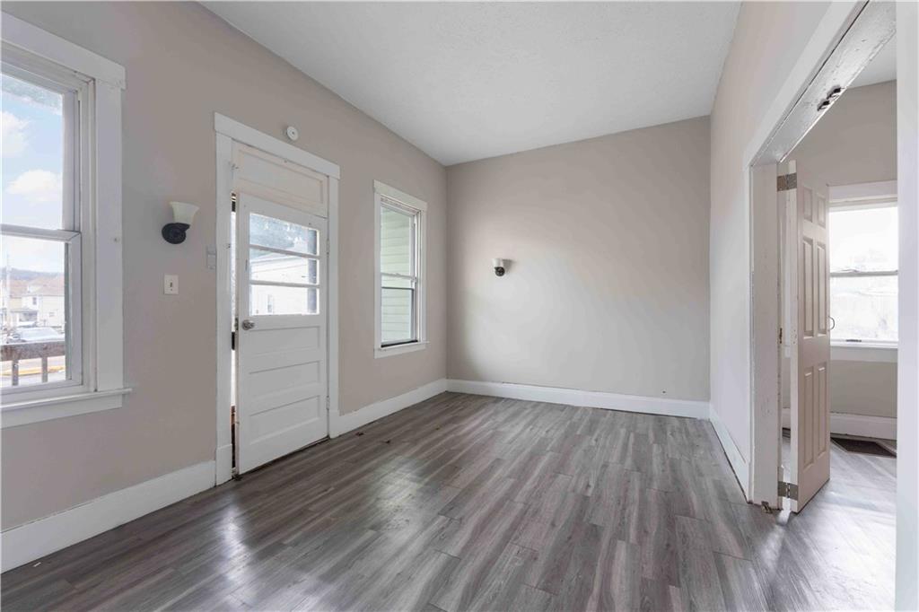 254-256 Pennsylvania Avenue Rochester, PA 15074 - Photo 13 of 32 an empty room with wooden floor and windows