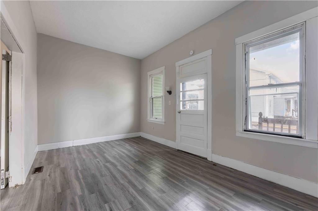 254-256 Pennsylvania Avenue Rochester, PA 15074 - Photo 19 of 32 an empty room with wooden floor and windows